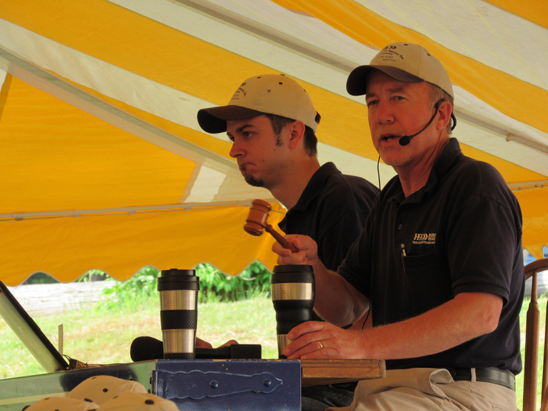 2 men working as auctioneers for a local pa auction